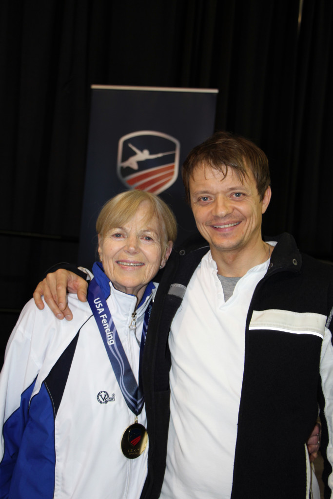 Lisa Dobloug celebrates her gold medal with her coach at DC Fencers Club, Robert Suchorski